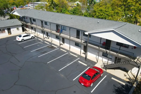 Amplio-Development-partners-view-from-above-of-building-of-two-floor-apartment-building-with-parking-lot